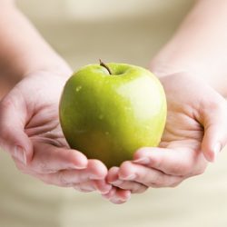 Woman holding fresh apple